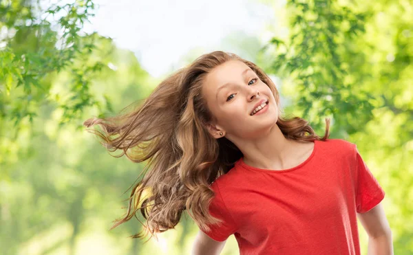 Smiling teenage girl over natural background — Stock Photo, Image