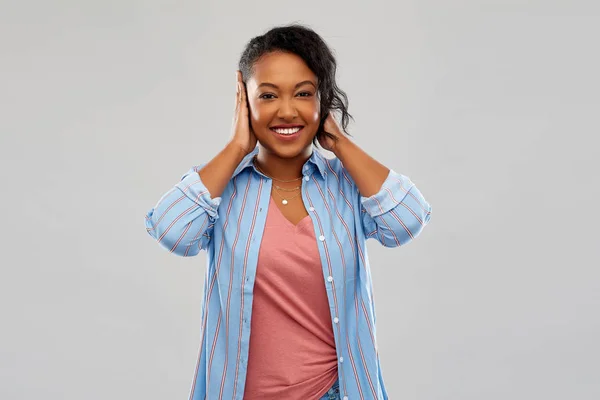 Feliz africano americano mujer cerrando orejas por las manos — Foto de Stock