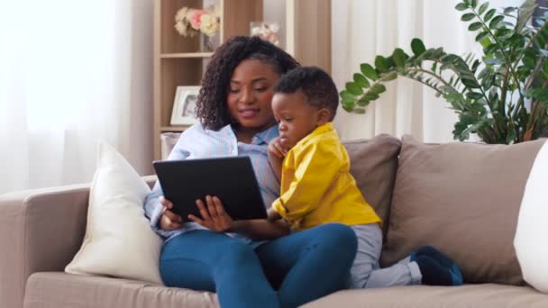 Madre usando tableta pc con el bebé hijo en casa — Vídeo de stock