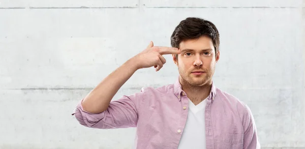 Bored man shooting himself by finger gun gesture — Stock Photo, Image