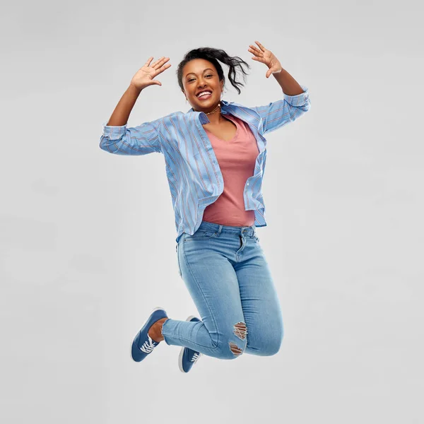 Onnellinen afrikkalainen amerikkalainen nainen hyppää korkealle — kuvapankkivalokuva