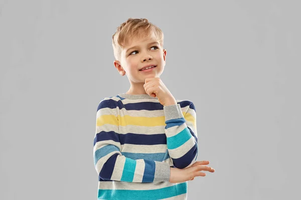 Portrait of thinking boy in striped pullover — Stock Photo, Image