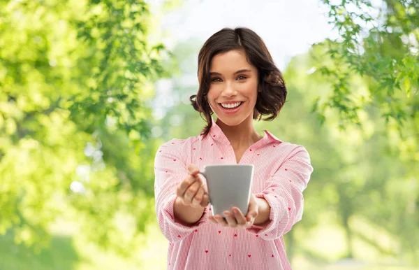 Happy young woman in pajama with mug of coffee — Stock Photo, Image