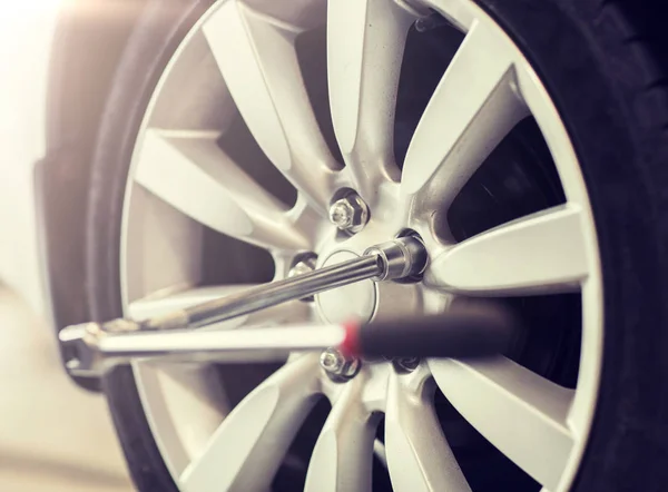 Screwdriver and car wheel tire — Stock Photo, Image