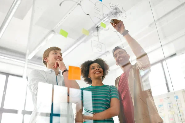 Happy creative team at office glass board — Stock Photo, Image