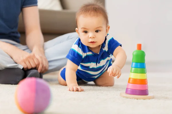 Bambino con padre e piramide giocattolo a casa — Foto Stock