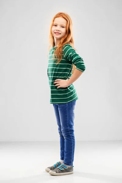 Smiling red haired girl posing in striped shirt — Stock Photo, Image