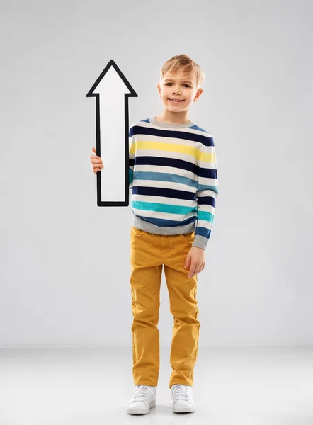 Boy in striped pullover with upwards thick arrow — Stock Photo, Image