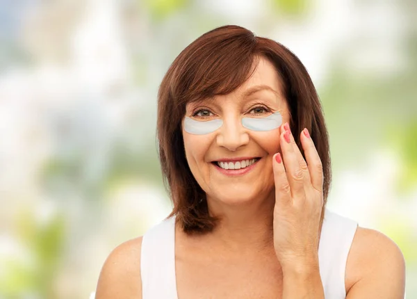 Happy senior woman with hydrogel under-eye patches — Stock Photo, Image