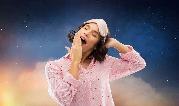 Happy young woman in pajama and eye sleeping mask — Stock Photo, Image