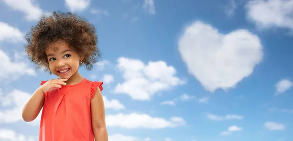 Happy little african american girl over blue sky — Stock Photo, Image