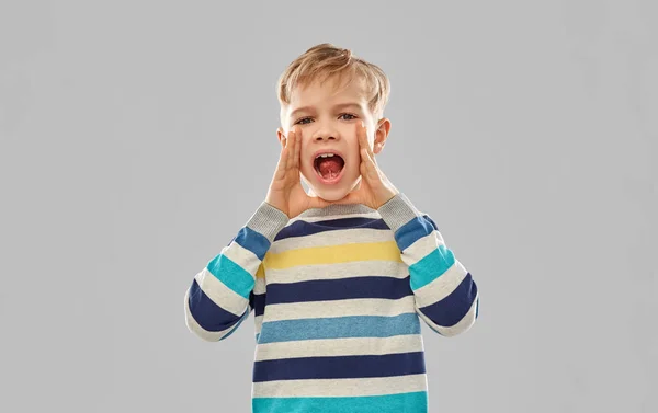 Little boy in striped pullover calling someone — Stock Photo, Image