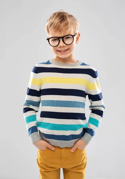 Smiling boy in glasses and striped pullover — Stock Photo, Image