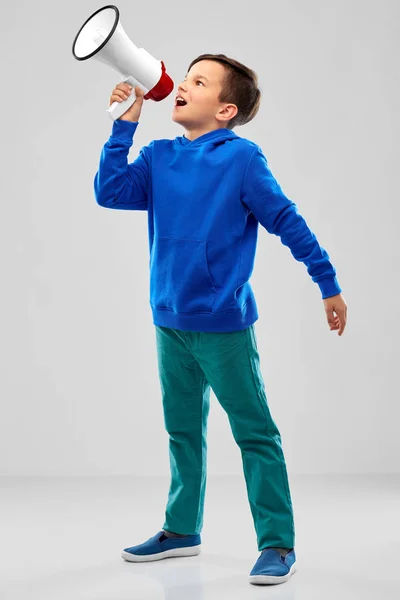 Smiling boy speaking to megaphone — Stock Photo, Image