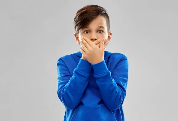 Shocked boy closing mouth by hands — Stock Photo, Image