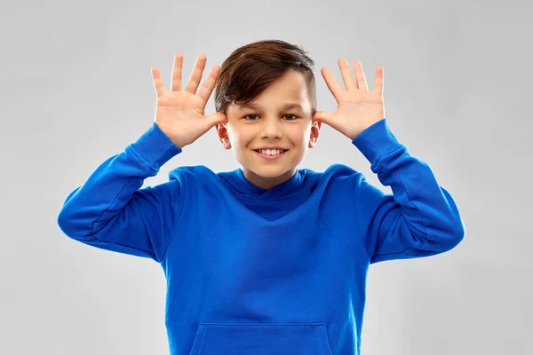 Happy boy having fun and making big ears — Stock Photo, Image