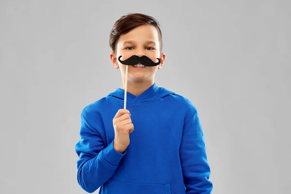 Smiling boy in blue hoodie with black moustaches — Stock Photo, Image