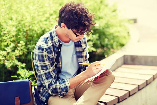 Man with notebook or diary writing on city street — Stock Photo, Image