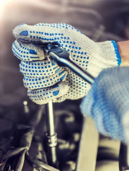 Meccanico con chiave inglese che ripara auto in officina — Foto Stock