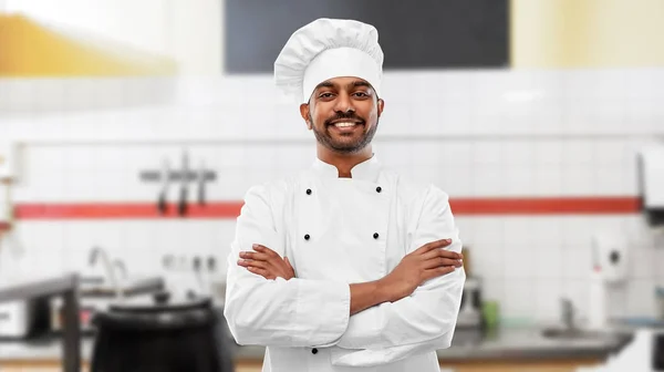 Happy indian chef in toque at restaurant kitchen — Stock Photo, Image