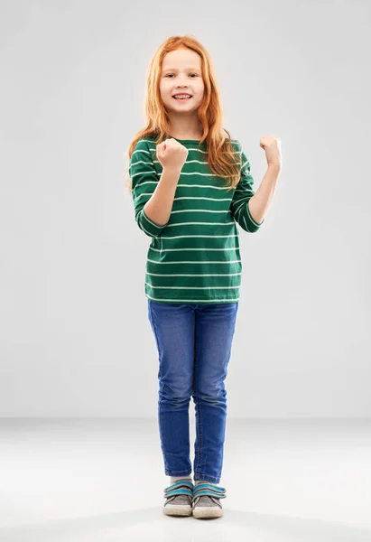 Smiling red haired girl celebrating success — Stock Photo, Image