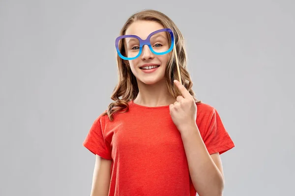Улыбающаяся девочка в очках для вечеринок — стоковое фото