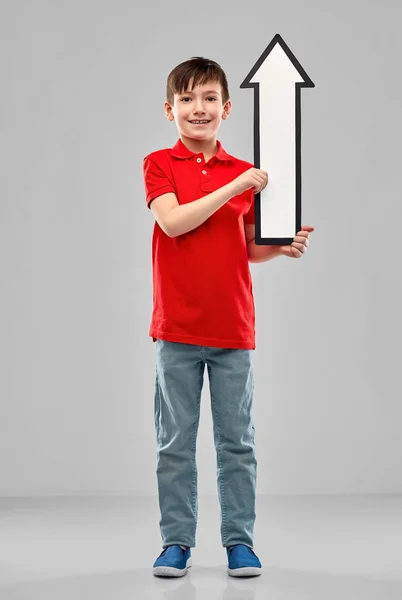 Boy holding big white upwards thick arrow — Stock Photo, Image