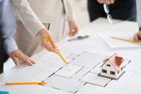 Close up of architects with blueprint at office — Stock Photo, Image