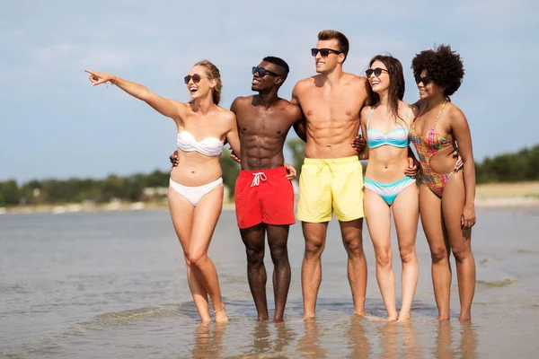 Amici felici che si abbracciano sulla spiaggia estiva — Foto Stock