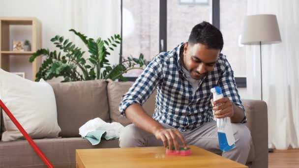 Indian man cleaning table with detergent at home — Stock Video