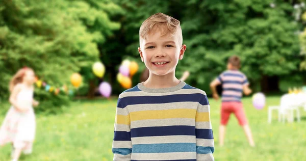 Menino sorridente na festa de aniversário no parque de verão — Fotografia de Stock