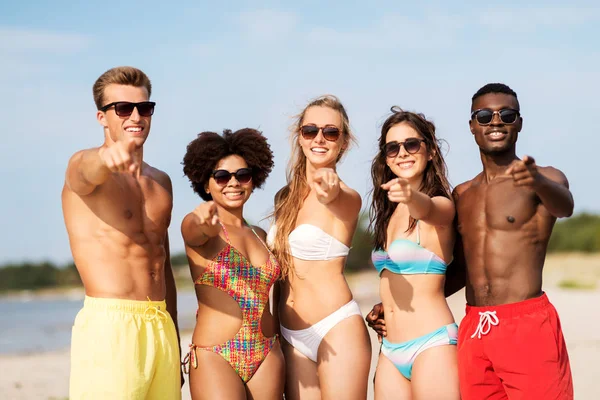 Amigos felizes na praia de verão apontando para você — Fotografia de Stock