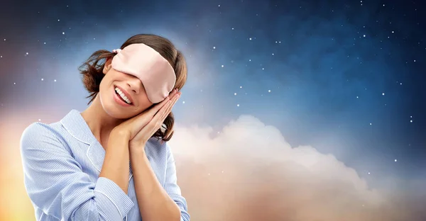 Happy young woman in pajama and eye sleeping mask — Stock Photo, Image