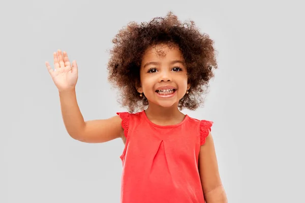 Happy little african american girl waving hand — Stock Photo, Image