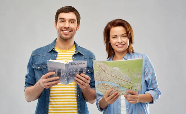 Šťastný pár turistů s vodítkem města a mapou — Stock fotografie