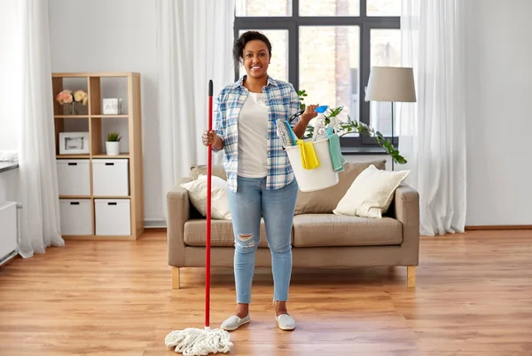 Woman with mop and other cleaning stuff at home — Stok fotoğraf