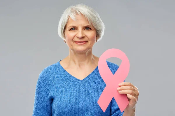 Old woman with pink breast cancer awareness ribbon — Stock Photo, Image