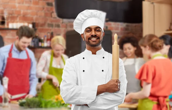Male indian chef with rolling-pin at cooking class — Stock Photo, Image