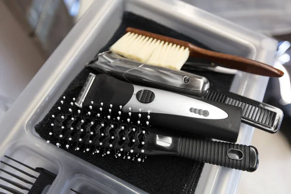 Brushes, trimmers and comb on tray at hair salon — Stock Photo, Image