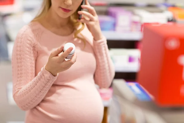 Zwangere vrouw kiezen geneeskunde bij apotheek — Stockfoto
