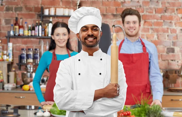 Male indian chef with rolling-pin at cooking class — Stock Photo, Image