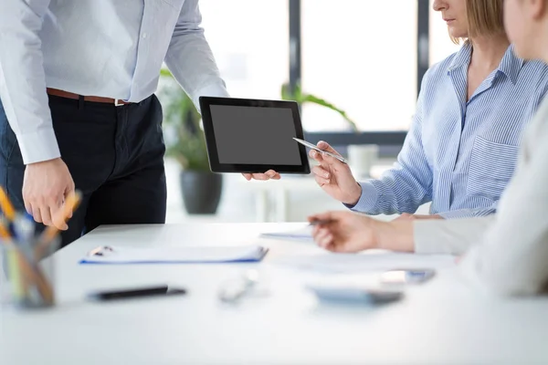Close up of business team with tablet pc at office — Stock Photo, Image