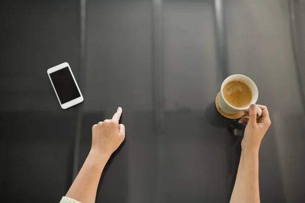 Жінка з кавою за допомогою чорної інтерактивної панелі — стокове фото