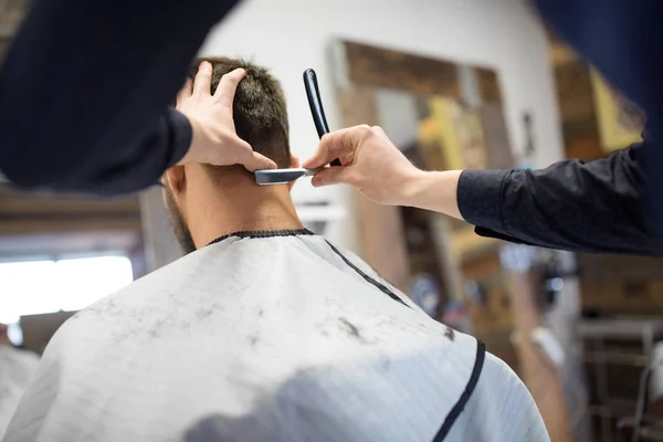 Man and barber with straight razor shaving hair — Stock Photo, Image