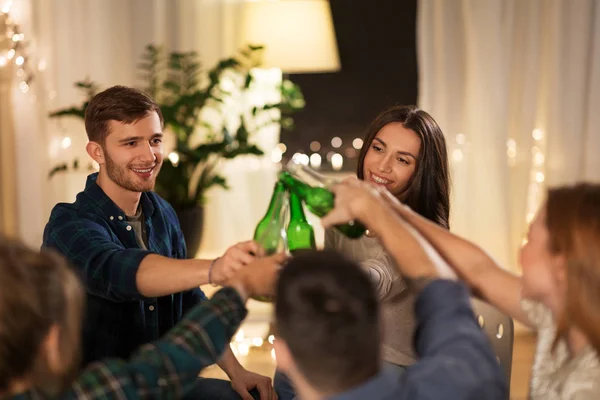 Friends clinking drinks at home in evening — Stock Photo, Image