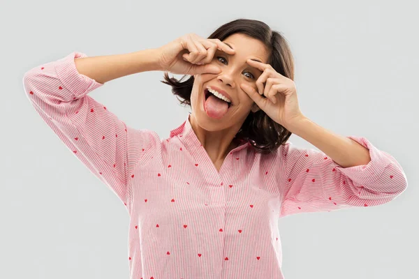 Happy young woman in pajama opening her eyes — Stock Photo, Image