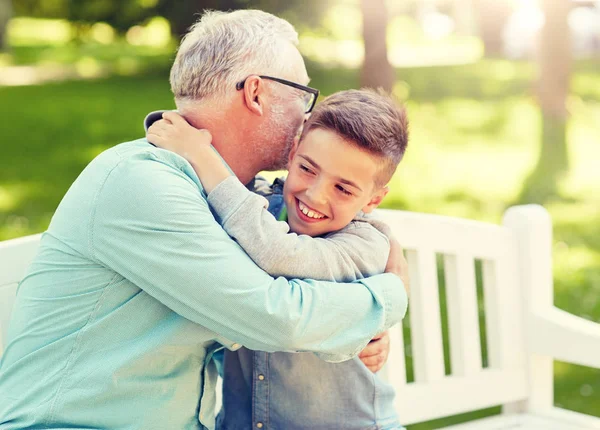 Grandfather and grandson hugging at summer park — Stock Photo, Image