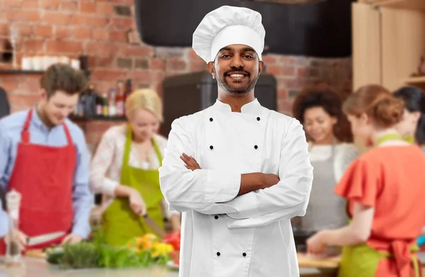 Happy male indian chef in toque at cooking class — Stock Photo, Image