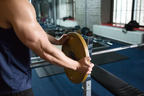 Close up of man with barbell weight in gym — Stock Photo, Image