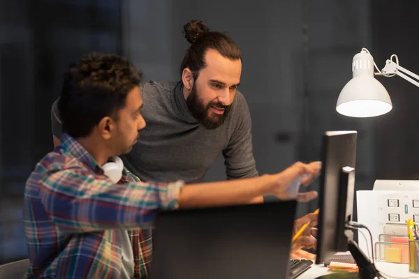 Creative team with computer working late at office — Stock Photo, Image